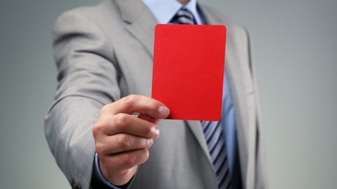 Showing the red card concept for bad business practice, exclusio